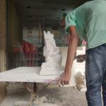 An artist spraying on an idol. (Ajay Tomar/South First)