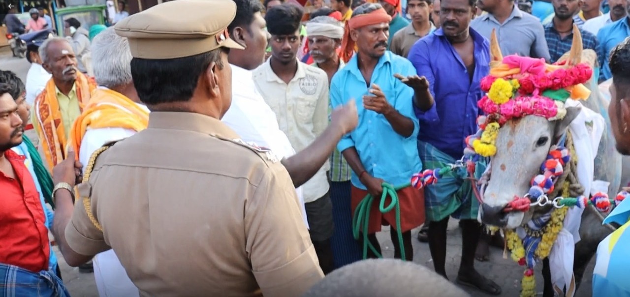 A police officer blocks people from the Dalit community people from taking their temple bull to the Jallikattu arena. (Supplied)
