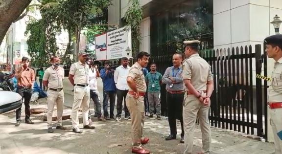 A police team in front of the victim's office conducting inquiries on Wednesday