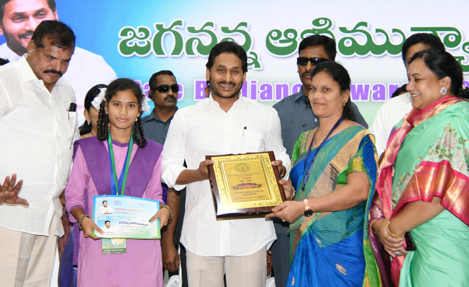 Chief Minister YS Jagan Moham Reddy presenting the Animutyalu Award to students in Vijayawada on Tuesday. Education Minister Botcha Satyanarayana (L) looks on. (Supplied)