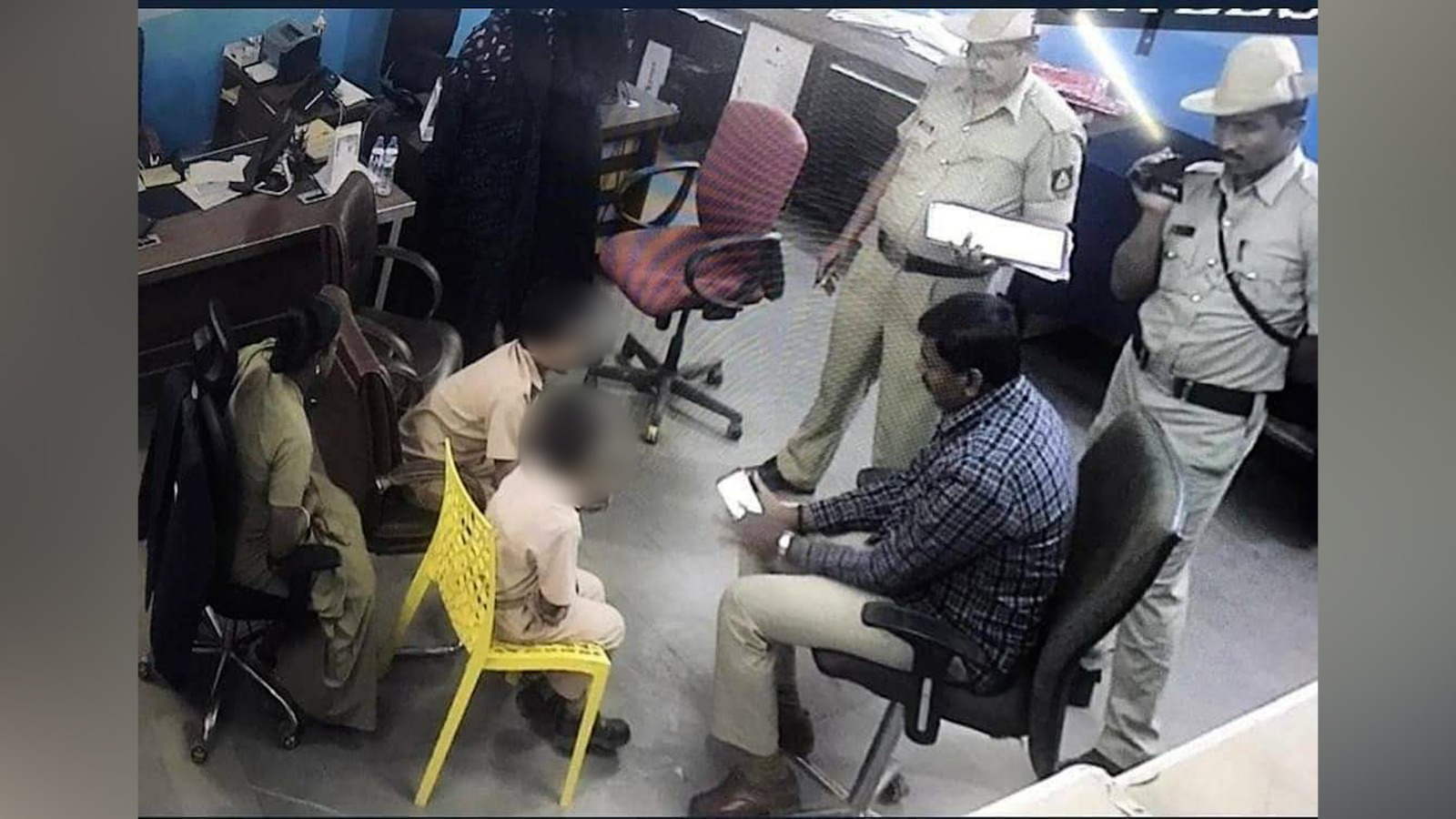 School students being questioned by the police while the cops video-graph the session