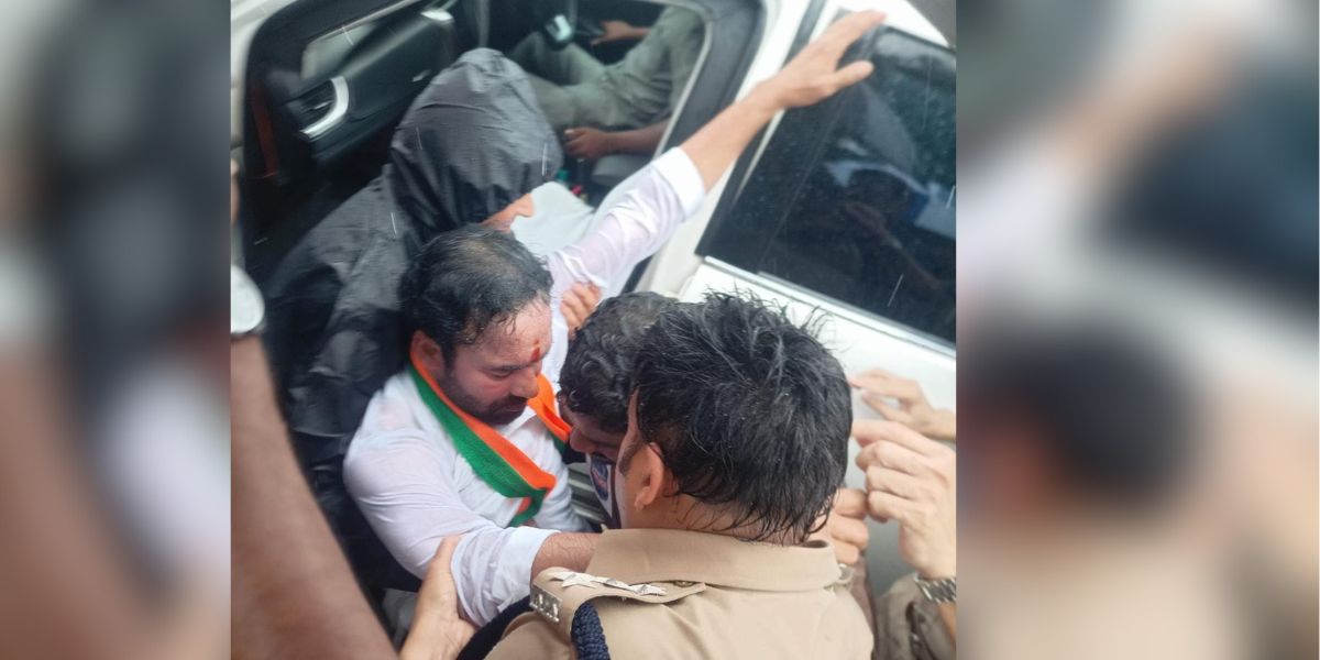 Telangana BJP chief Kishan Reddy prevented by police from visiting housing project site; sits on road in protest