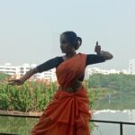 A photo of a woman performing at the lake premises