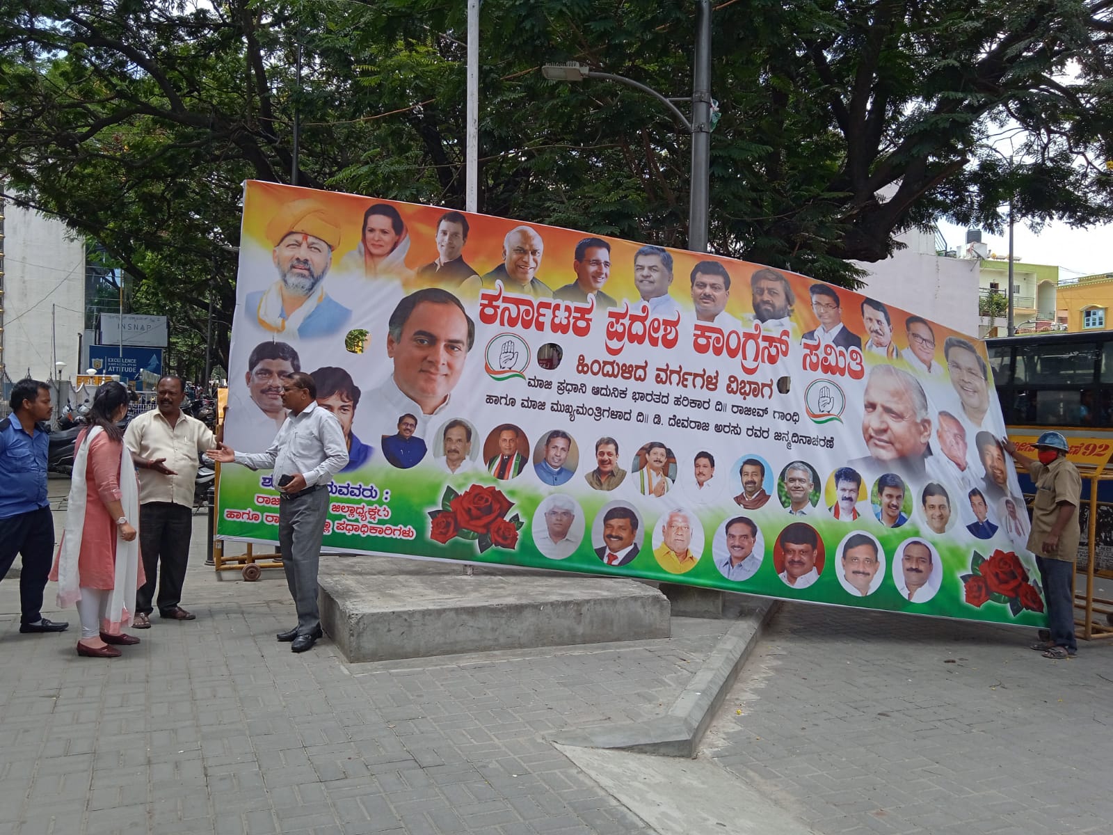 Officials from BBMP's Vasanthanagar Sub-division removing the illegal flex banner put up in front of the KPCC office in Bengaluru. (Supplied)