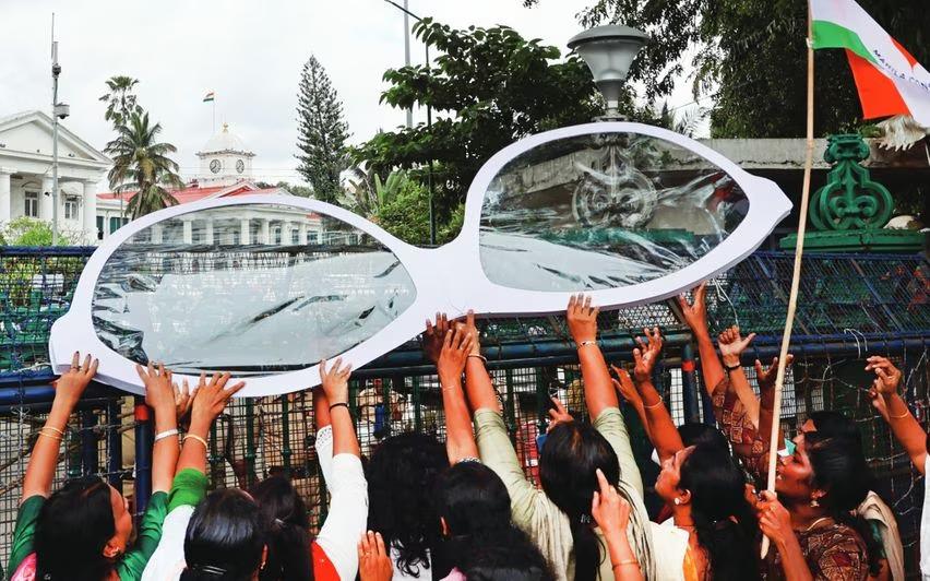 Mahila Congress workers protesting the splurge on reading glasses out the Secretariat. (Supplied)