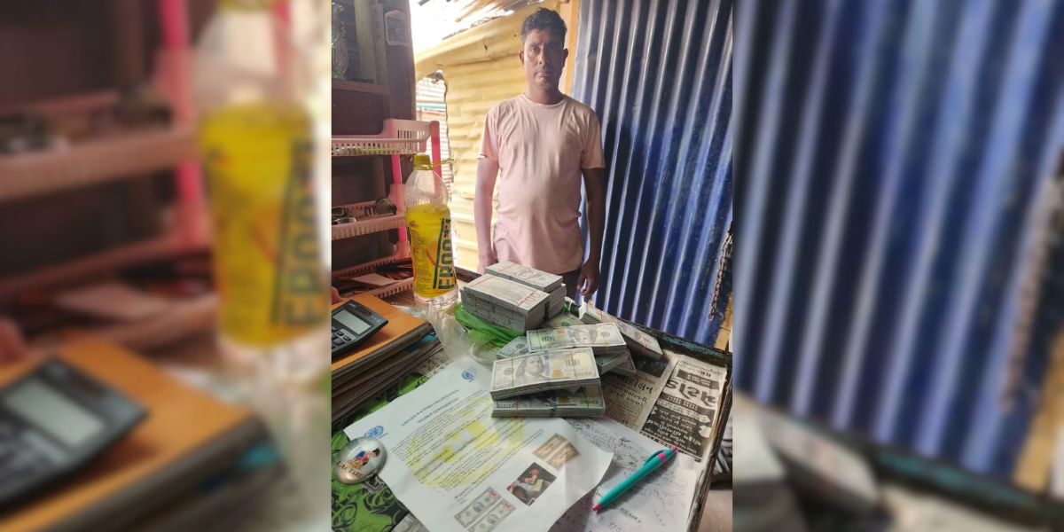 Saleman Sheikh with the fake US dollar bundles and the purported letter from the UN at his shanty.