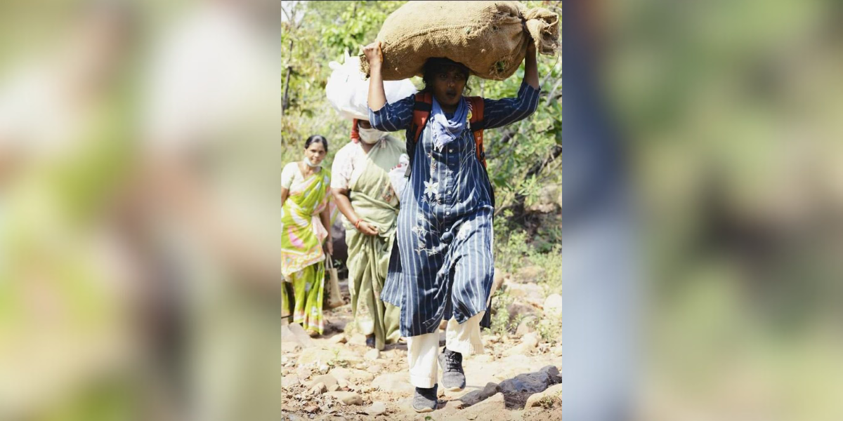 Taslima walking with provisions for tribals in Mulugu during the Covid-19 pandemic. (Supplied)