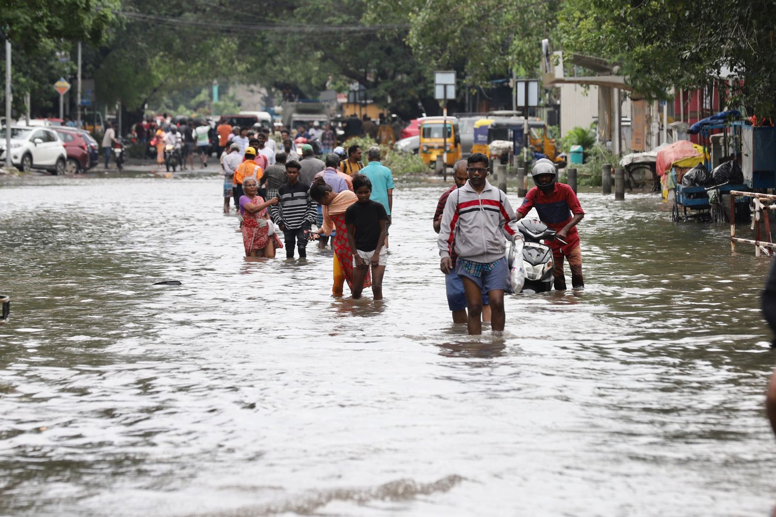 People walking through the flooded roads in Chennai.