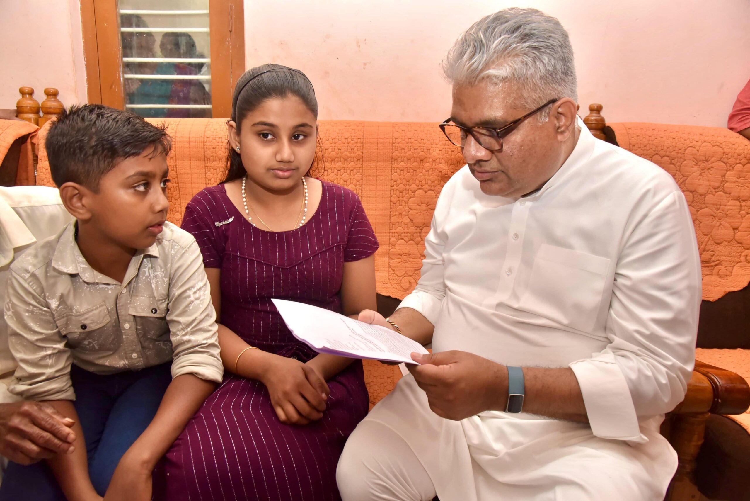 Union Minister Bhupender Yadav with the family of Ajeesh on Wednesday, 21 February. Ajeesh was trampled to death by a wild elephant identified as Belur makhana on 10 February. (X)