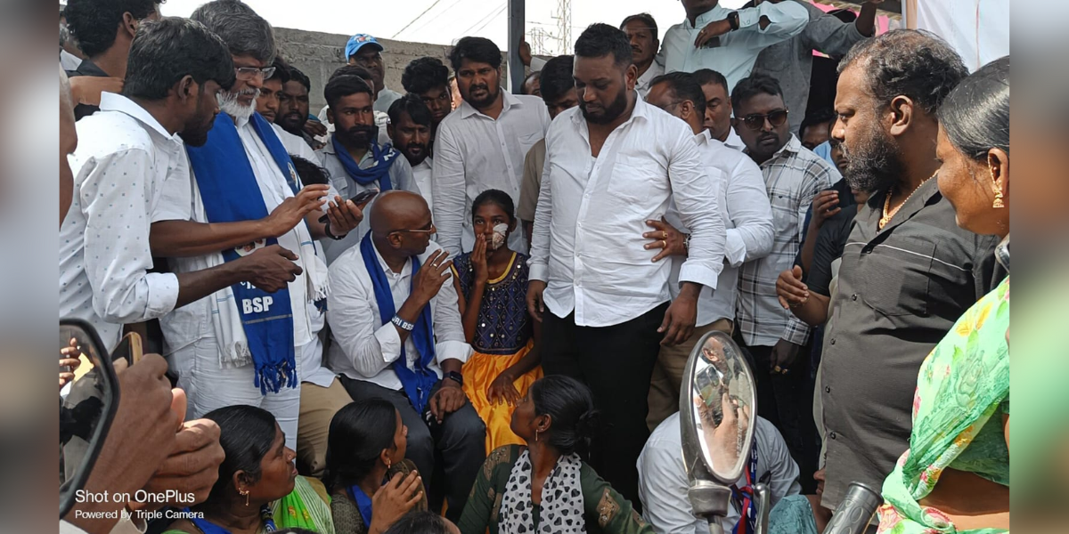 BSP state president RS Praveen Kumar with a child victim who was bleeding after the assault. (Supplied)