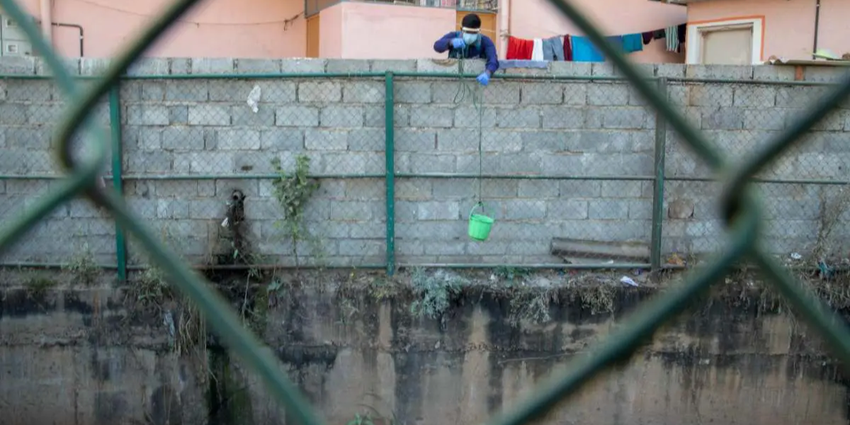 Researcher drawing water from STPs for wastewater surveillance (#COVIDActionCollab)