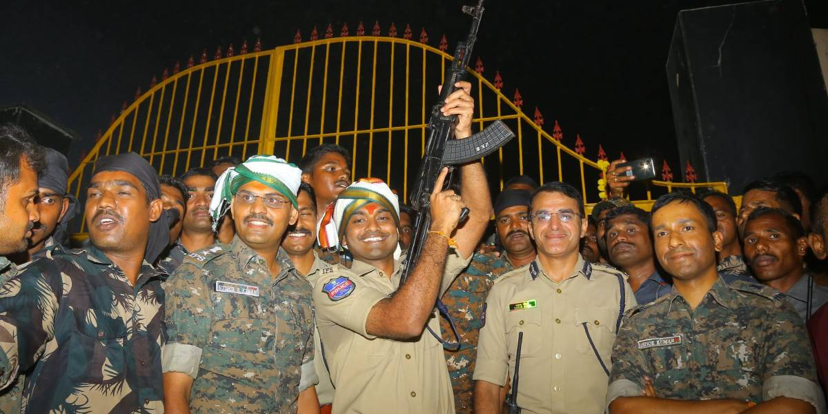 Mulugu Superintendent of Police P Shabarish fires three rounds into the air at the Medaram Jatara. (Supplied)
