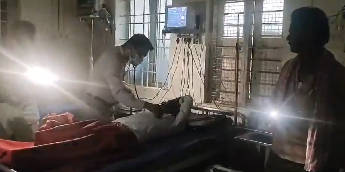Doctor treats patient with mobile phone flashlight