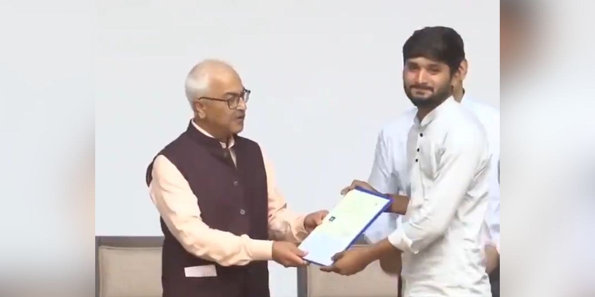 Home Secretary Ajay Kumar Bhalla handing over citizenship certificate.
