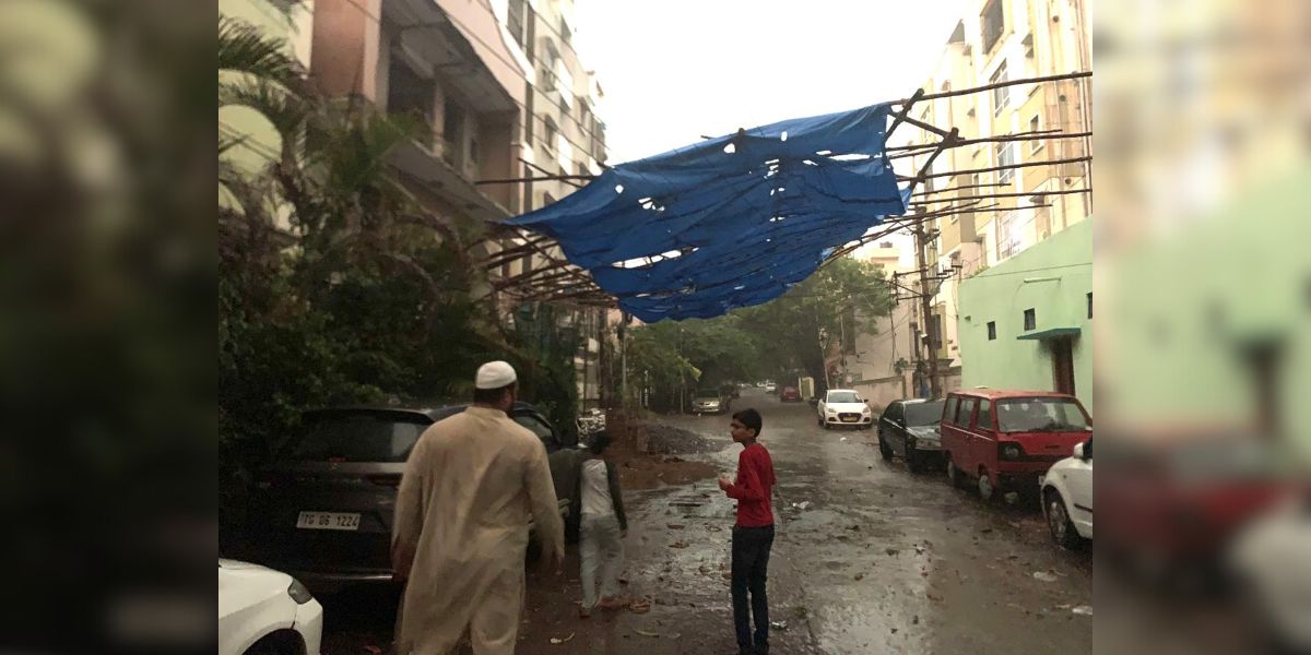 People venture out in the rain in Hyderabad on Tuesday, 7 May, 2024.
