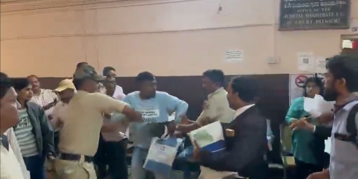 Police taking away Jayesh Poojari after he raised pro-Pakistan slogans.