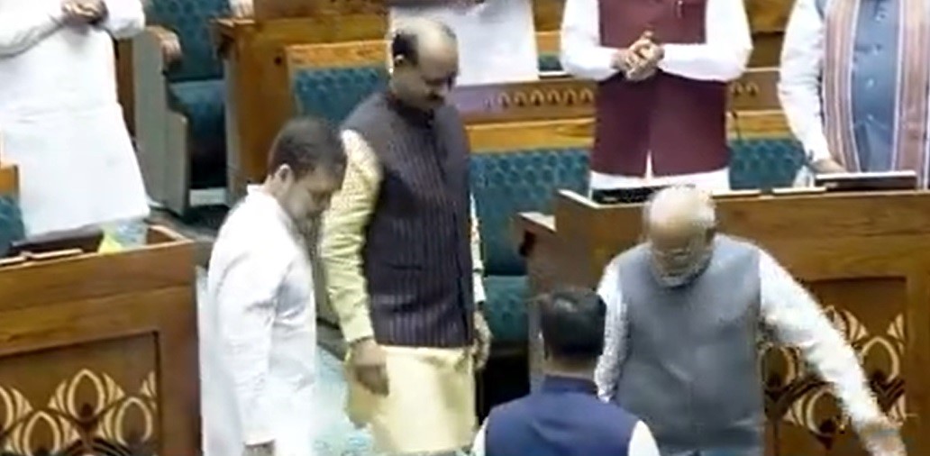 Prime Minister Narendra Modi and Opposition Leader Rahul Gandhi escort Om Birla to the chair. (Sreengrab)