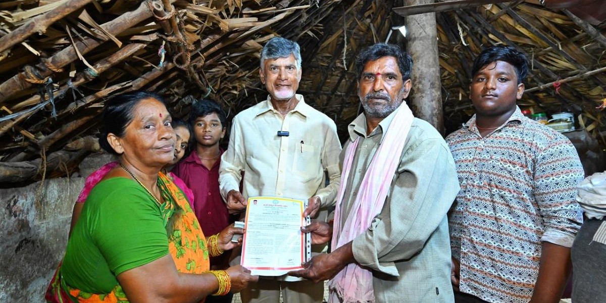 Naidu distributing social security pension to a family in Penumaka, near Vijayawada