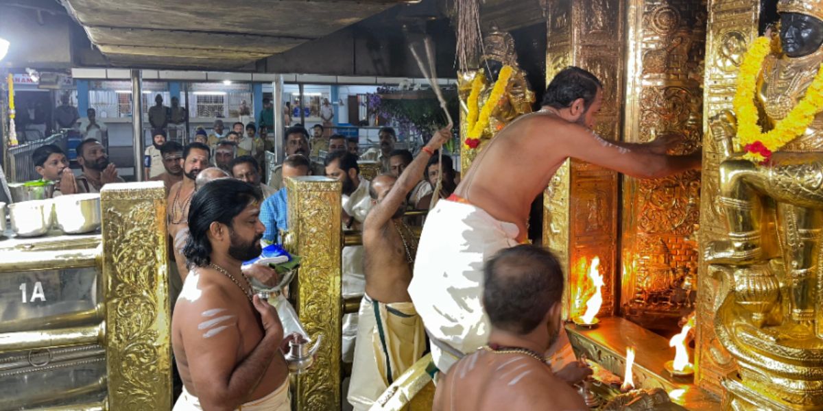 A priest opening the sanctum sanctorum of the Sabarimala Temple.