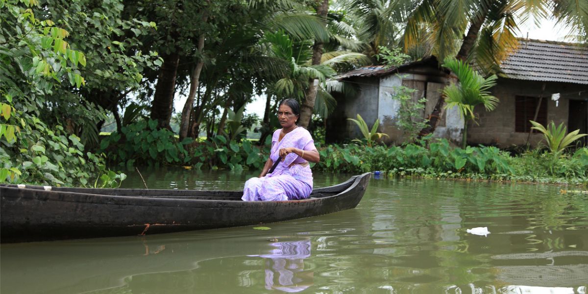 A woman rowing a small boat in the backwaters of Kerala. (iStock)