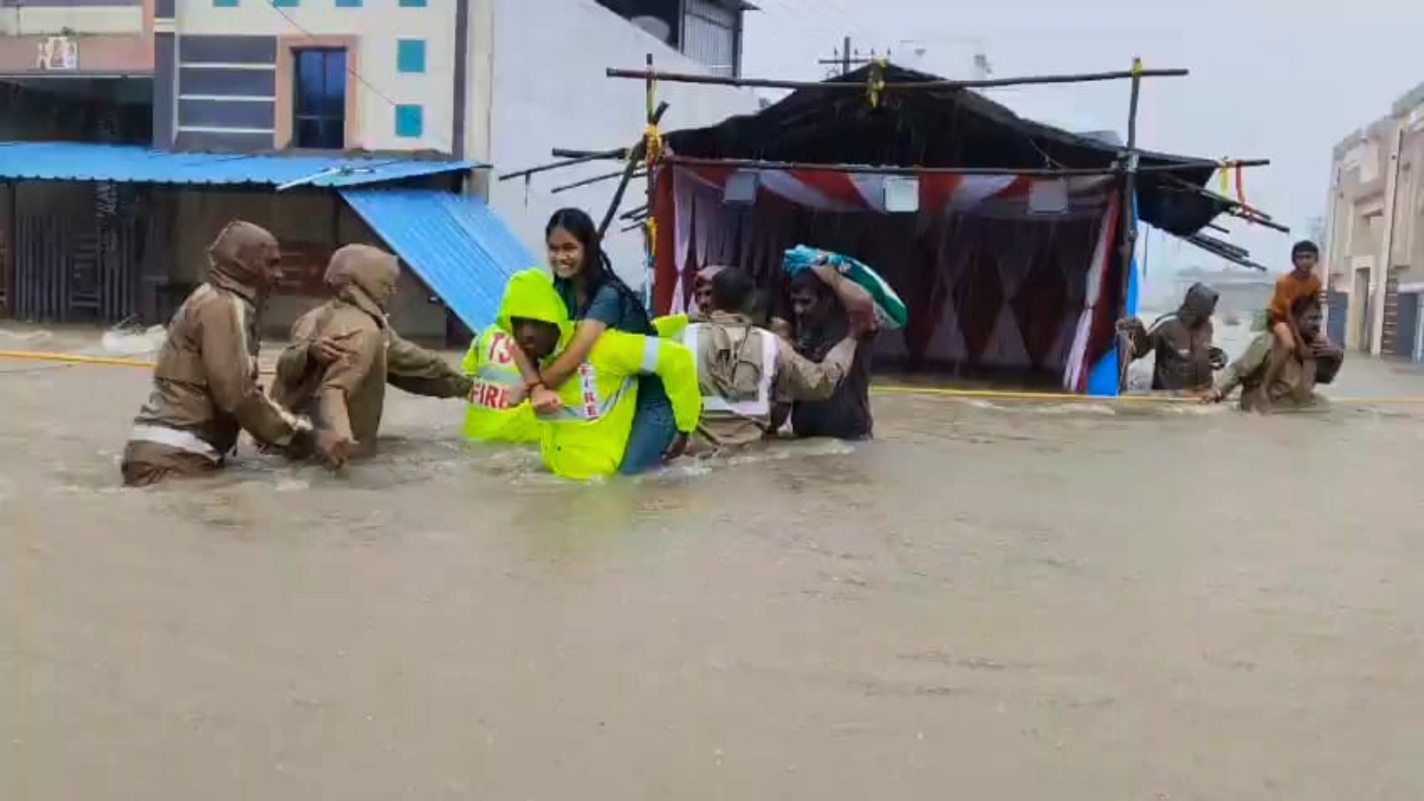 A student being carried across the water in Medak