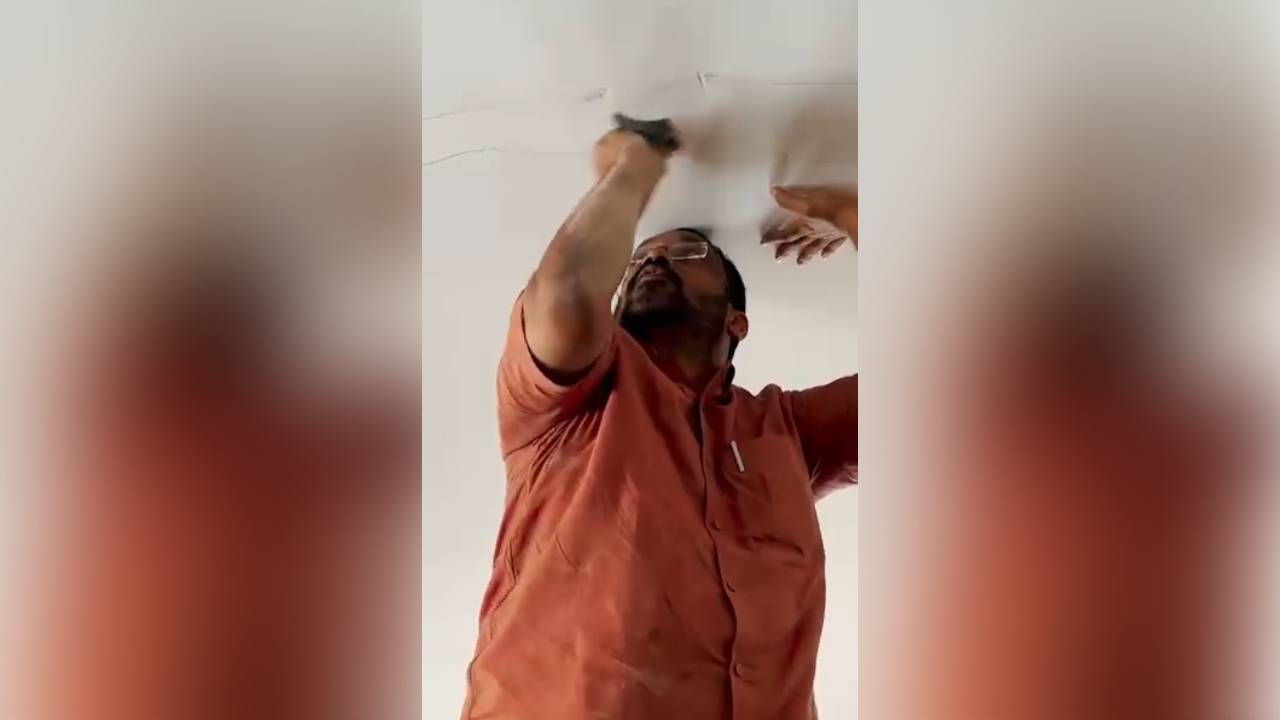 Revenue Minister K Rajan taking a close look at the alleged crack on the ceiling.