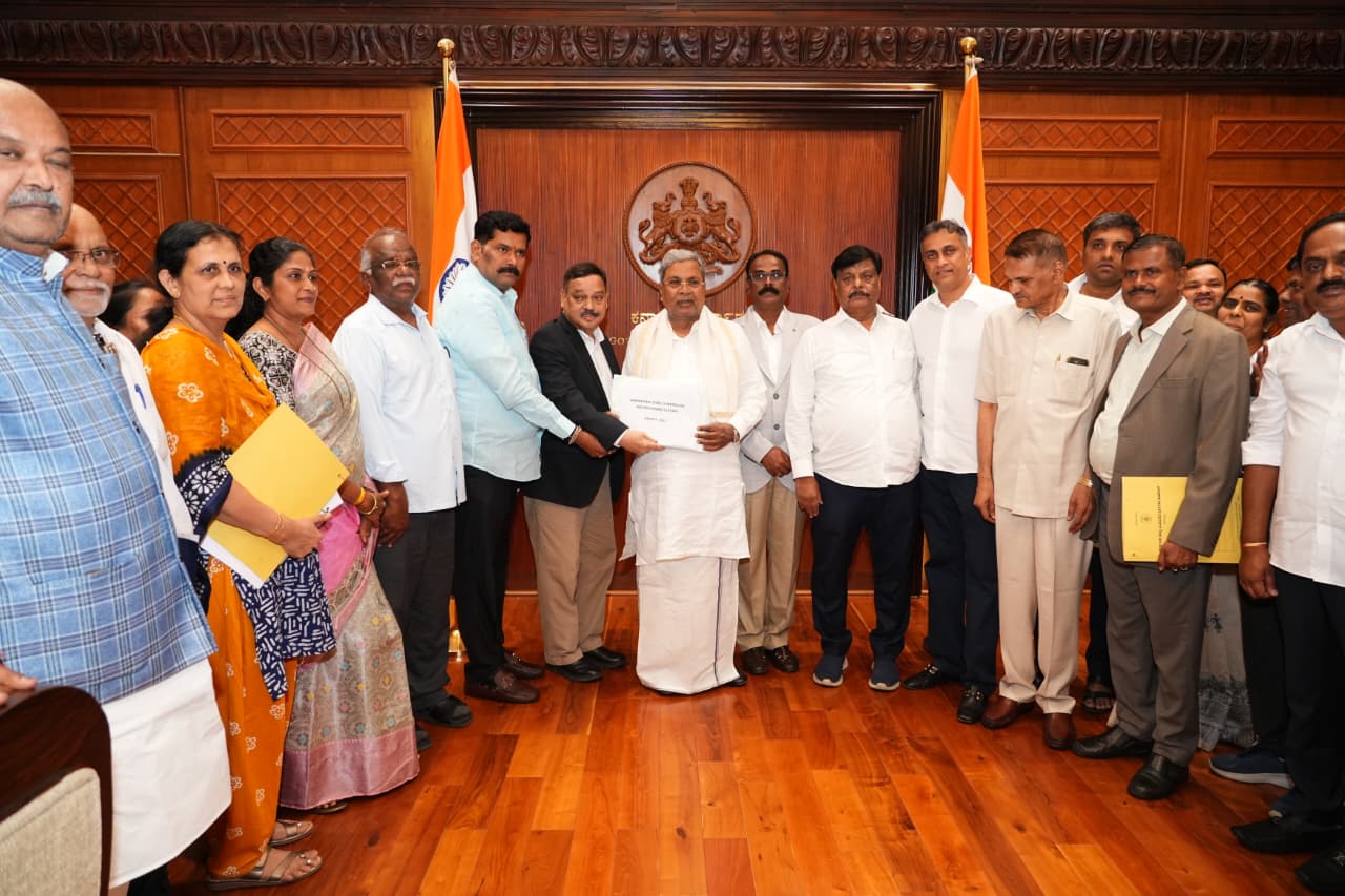CM Siddaramaiah receiving the report from Backward Classes Commission Chairman Madhusudan Nayak.