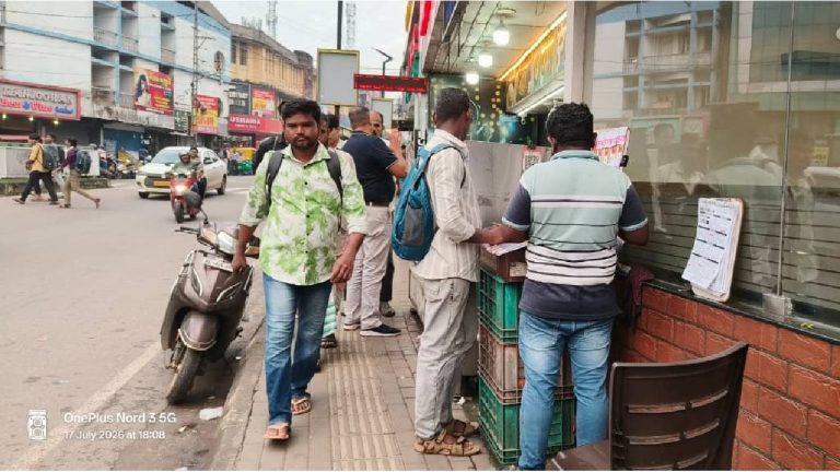 Aluva, 17 July: Customers waiting at a food counter force pedestrians to walk on the road. The eatery's takeaway counter opens to the footpath.