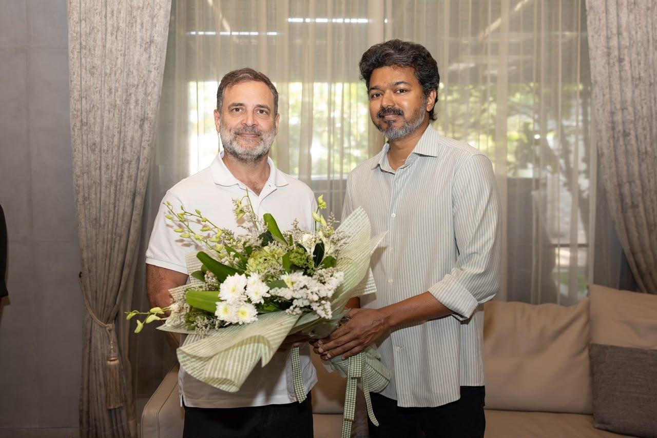Rahul Gandhi and Tamil Nadu Chief Minister C. Joseph Vijay stand together holding a bouquet of white flowers during a meeting in Chennai.