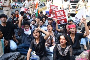 SFI activists stage a sit-in after the police prevented them from marching to the protest site.