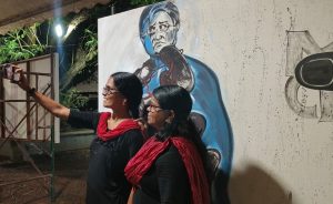 Women taking selfies with the paintings