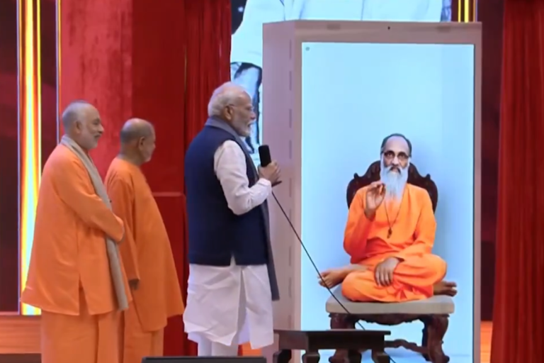 Prime Minister Narendra Modi interacts with holographic avatar of Swami Chinmayananda Saraswati at Chinmaya Amrit Mahotsav Global Sammelan.